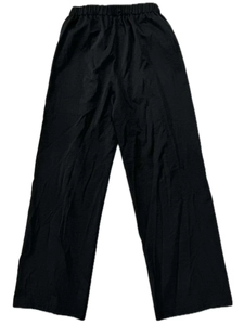 Detailed flat lay of black wide-leg casual pants showing the elastic waist and drape fabric