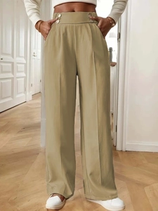 Detailed close-up of high-waisted khaki wide-leg trousers with decorative metal waist buckles