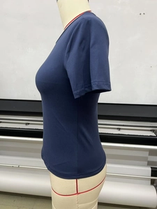 Detailed side view of navy blue slim fit t-shirt on a mannequin in a textile studio