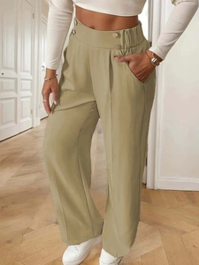 Detail view of khaki high-waisted wide-leg trousers with decorative waist buttons