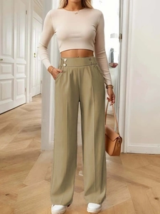 Detail view of khaki high-waisted wide-leg trousers with central seam and metal buckle