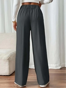 Rear view of high waist dark gray wide leg trousers with elastic waistband and drape