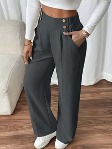 Close-up of high-waist wide-leg trousers in dark grey with golden decorative button detail