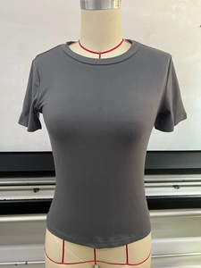 Detail of soft charcoal grey knitted fabric and stitching on a slim-fit crewneck T-shirt