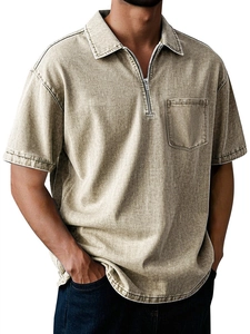 Detail of vintage washed khaki cotton polo with zipper collar and single chest pocket