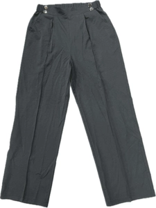 Detailed view of high waist black wide leg trousers featuring silver buttons and pleats