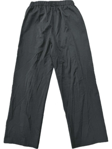 Detailed view of elastic waistband and drawstring on high-waist loose fit linen trousers