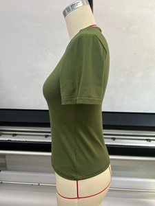 Detail view of olive green slim fit T-shirt on mannequin showing side seam and fabric texture