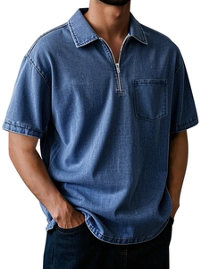 Detail of men's blue washed cotton polo shirt featuring a metal zipper and chest pocket