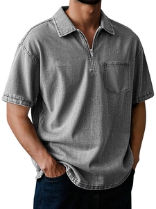 Detail of grey cotton polo shirt with metal half-zip, textured fabric, and chest pocket