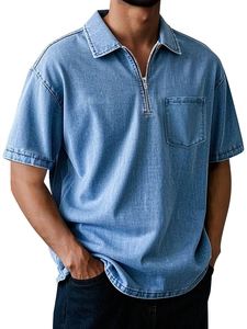 Detail of light blue denim polo shirt featuring a unique half-zip collar and chest pocket