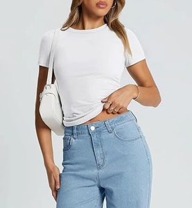 Detail of slim fit white crew neck T-shirt paired with light blue denim jeans