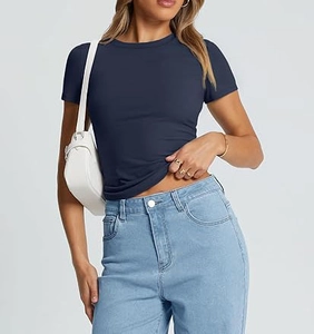 Close-up of slim fit navy blue crew neck T-shirt styled with denim and a white bag