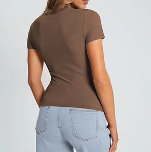 Rear view of woman wearing a slim-fit brown short-sleeved T-shirt with light blue jeans