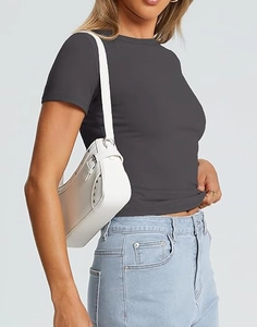 Detail of gray slim-fit crew neck T-shirt paired with denim jeans and studded white bag
