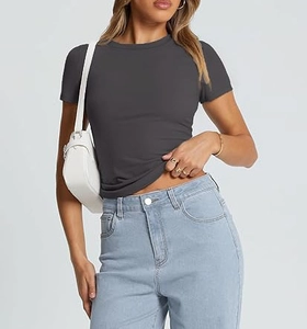 Detail of dark grey slim fit crew neck T-shirt paired with denim and white bag