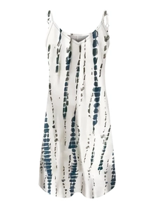 Detail of V-neckline and adjustable metal buckle straps on tie-dye summer dress