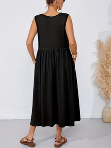 Rear view of a black sleeveless maxi dress showing draped silhouette and high waist pleats