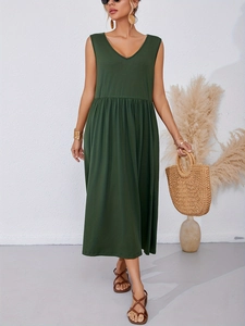 Detail of loose fit V-neck sleeveless dress featuring side pockets and high waist pleats