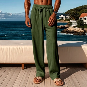 Detail of men's dark green vertical stripe trousers with drawstring elastic waistband