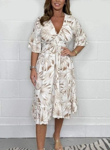 Detail of V-neckline and tropical leaf print on this high waist summer dress