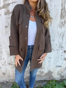 Detail of wool coat with large utility flap pockets and buttoned three-quarter sleeves