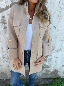 Detail of camel wool jacket showing buttoned chest pockets and stand collar texture