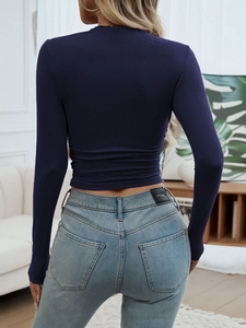 Detail view of navy slim fit crew neck top with side ruching and denim jeans