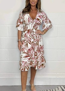 Detail of V-neckline and tropical leaf print on this high-waist summer midi dress