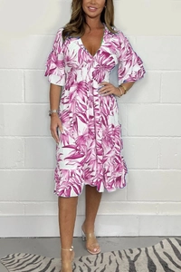 Detail of V-neckline and purple tropical leaf print on white smocked waist summer dress