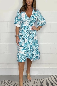 Detailed V-neck floral dress featuring blue tropical leaf print and smocked waist
