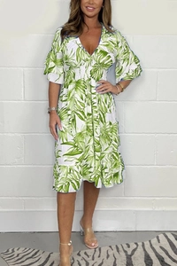 Close-up of smocked waist design and ruffle sleeves on tropical print summer dress