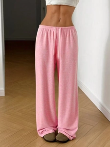 Detail of pink lightweight sweatpants showing elastic drawstring waistband and fabric texture