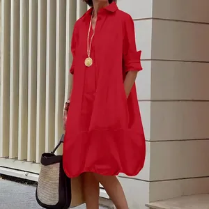 Elegant red long-sleeve button-down shirt dress with side pockets and loose silhouette
