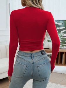 Detailed back view of a slim fit red long sleeve top featuring stylish ruched waist accents