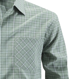 Macro detail of men's plaid shirt showing fabric texture and bias-cut chest pocket
