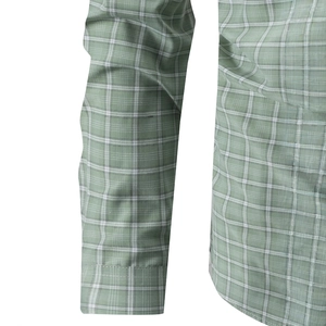 Detail of light green plaid shirt sleeve showing fine fabric texture and neat stitching