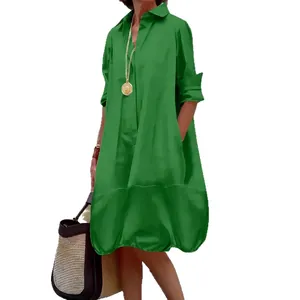 Emerald green button-down shirt dress with long sleeves and loose hem silhouette