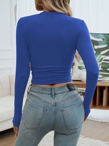 Back view of a slim fit Klein blue long sleeve crew neck crop top with high waist jeans