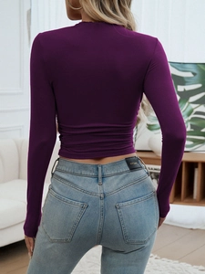 Detail of slim fit cropped long sleeve top in deep purple with soft elastic fabric