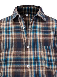 Detail of blue and brown plaid flannel shirt showing breast pocket and buttons