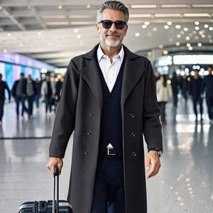 Men's double-breasted charcoal wool coat with slim fit design for elegant business travel