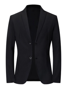 Detail of classic black blazer featuring notched lapels and two-button closure