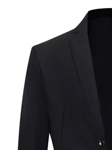 Detail view of business suit jacket notch lapel and shoulder padding in black fabric