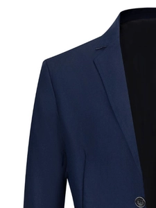 Detailed close-up of dark blue blazer showing notch lapel and fine stitching texture