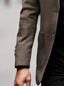 Detail of grey glen plaid suit jacket showing textured fabric and three-button cuffs
