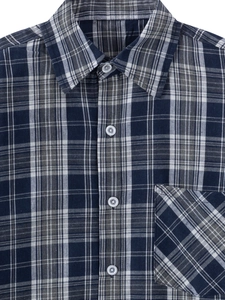 Detail of classic navy blue and grey plaid men's shirt with diagonal pocket texture