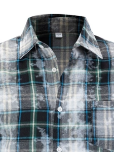 Detail view of men's plaid shirt with unique white bleached finish and chest pocket