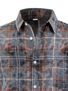 Close-up of a checkered long-sleeve shirt with grey and brown flannel texture and white buttons