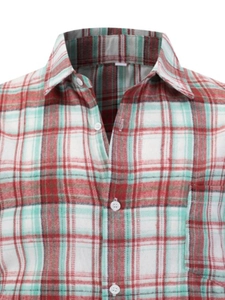 Detail of red and green plaid shirt showing collar, chest pocket and button texture